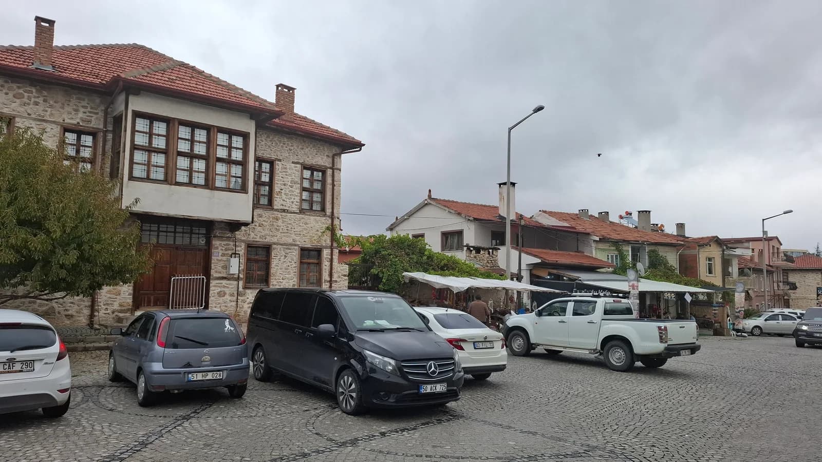Timber upper-floor houses and shops around the square by Eşrefoğlu Mosque.
