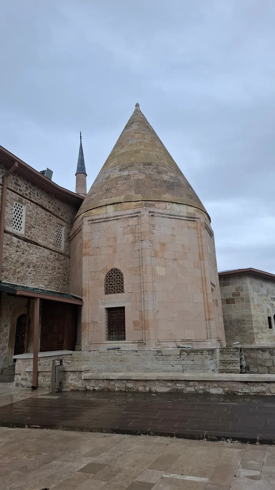 The conical-roofed tomb beside Eşrefoğlu Mosque.
